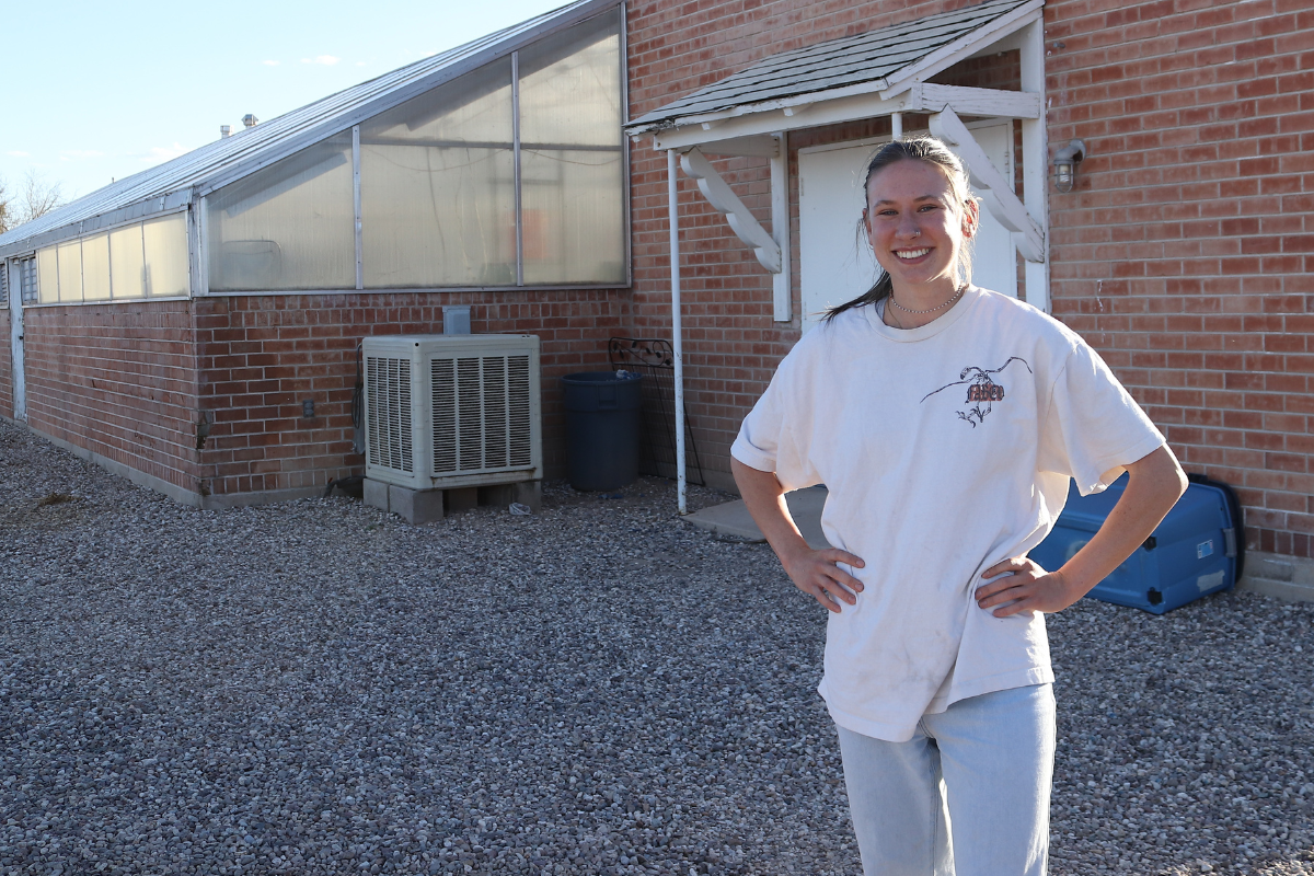 Project Manager Gracie Reinholz standing outside the greenhouse at the CEAC.