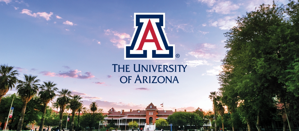 Old Main at sunset with the University of Arizona logo in the sky above the building