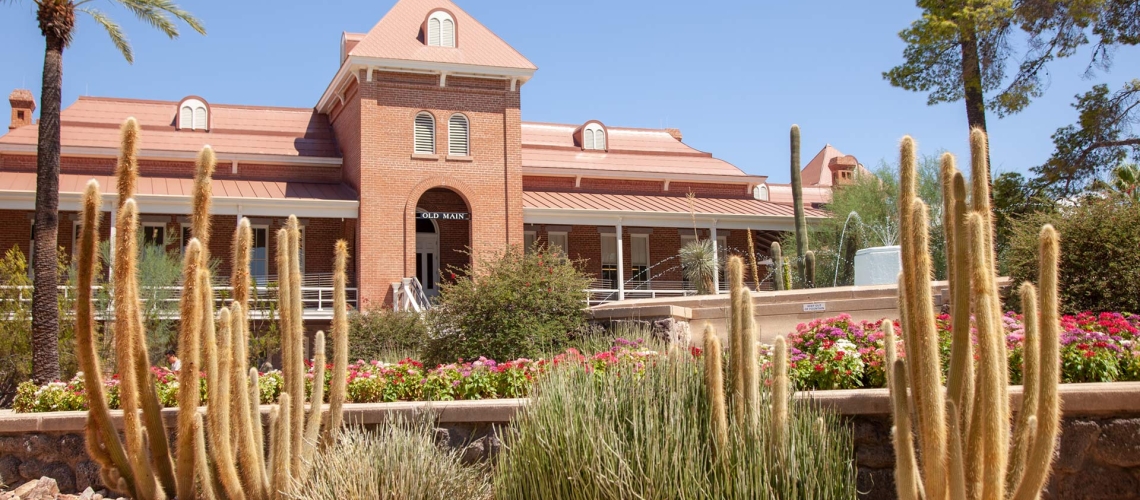 Old main with cacti in the foreground