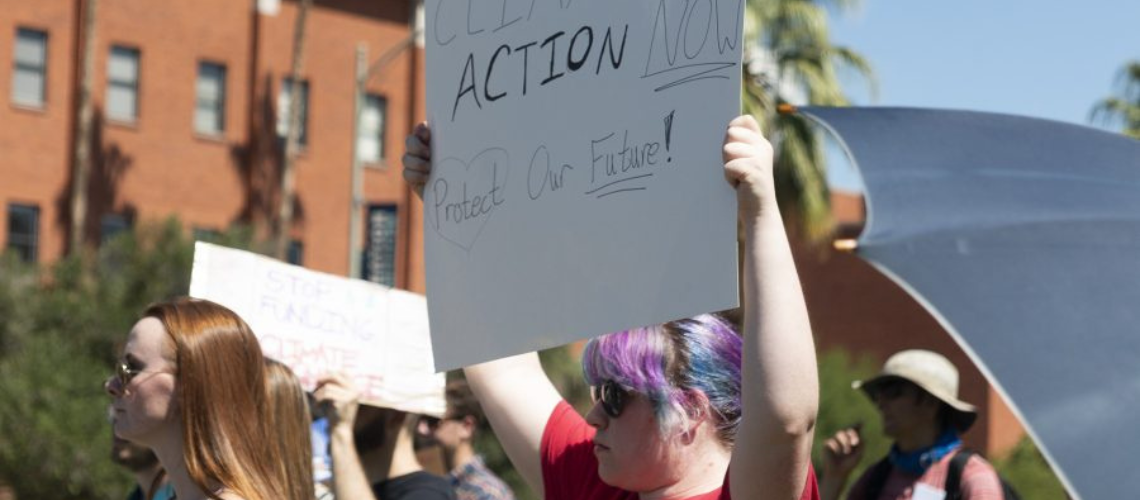 University students gather on the UA Mall on Friday, Sept. 23 2022. A sign reads Climate Action Now, Protect Our Future. 