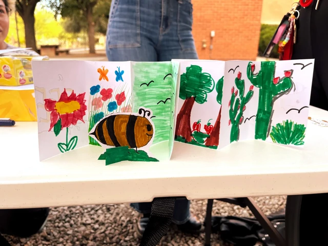 A paper folded into a pamphlet style that has drawings of flowers, bees, and trees.