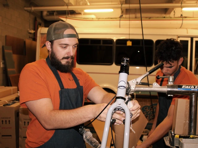 Two people fixing a bike. 