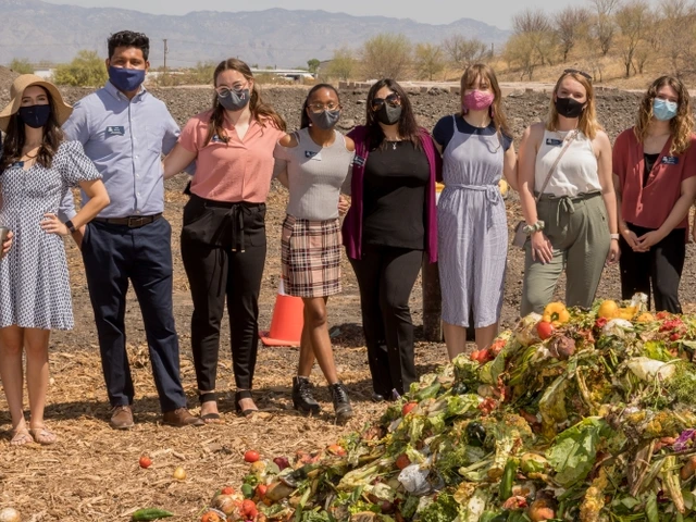Compost Cats team with a pile of food waste in the foreground. 