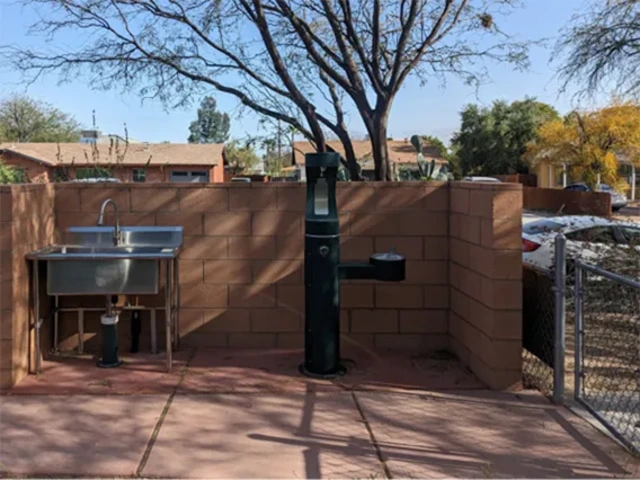 A water fountain and sink installation in the Community Garden.