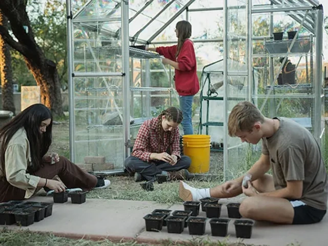 Student volunteers starting seeds in pots for the Garden's greenhouse.