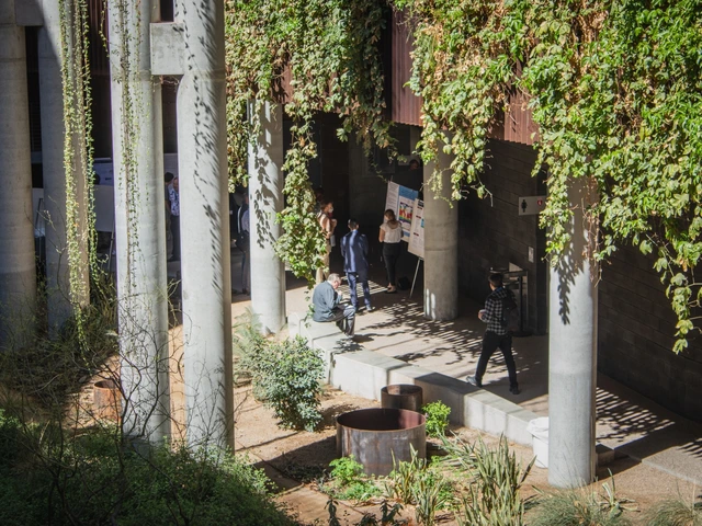 A group of people attending poster presentations. 