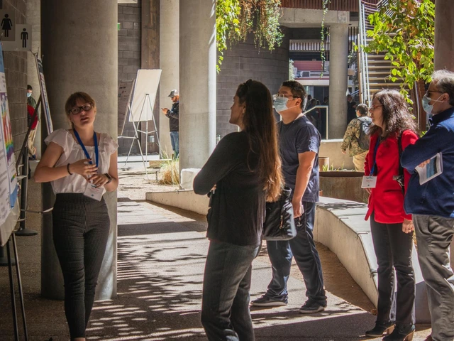 One individual presents their research poster to an audience of 4 individuals. 