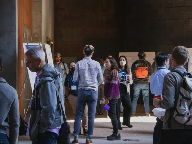 A group of people attending poster presentations. 