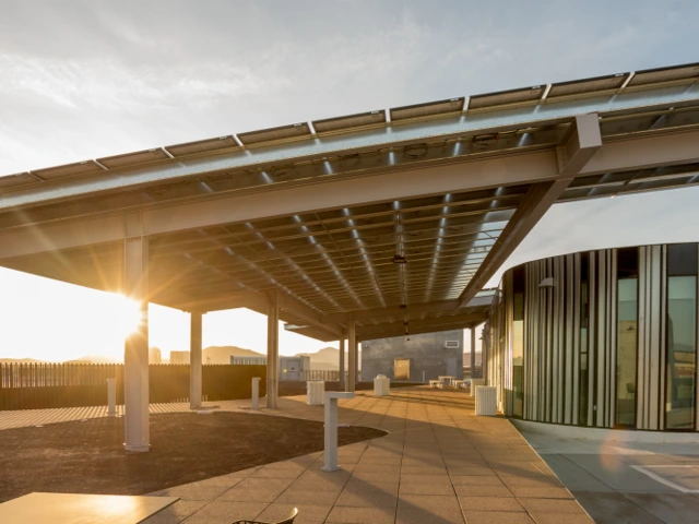 Solar panel installation with sun in background. 