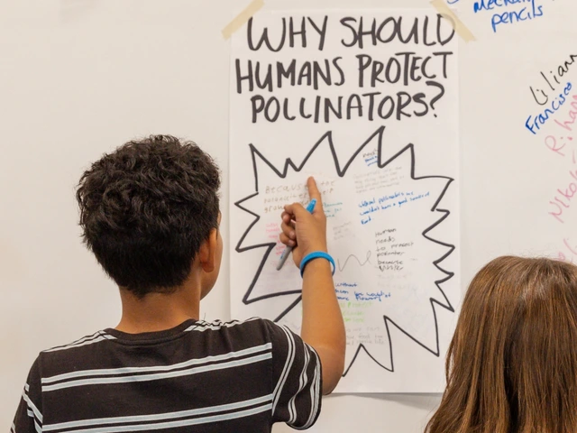 Two people standing in front of a white board where a piece of paper is taped to the whiteboard. They are writing on the paper. 
