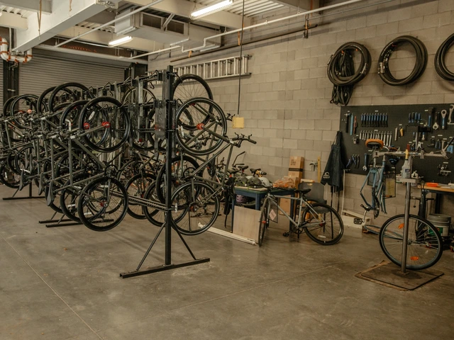A bike workshop area where multiple bikes are hung up on a bike rack.