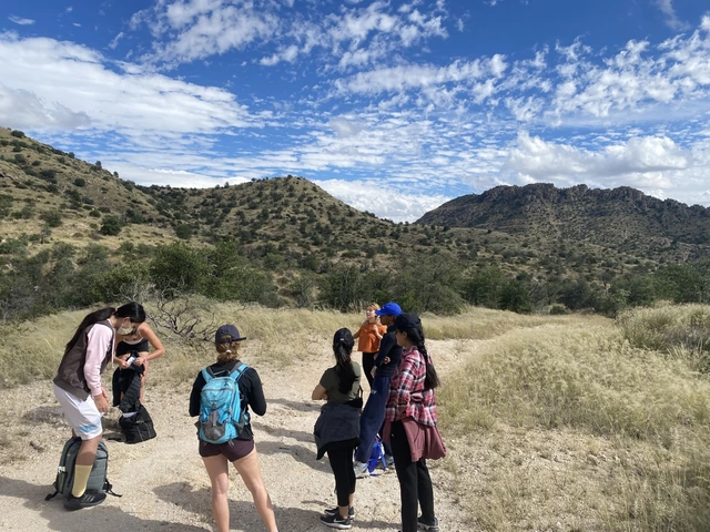 A group of students talking before hiking.