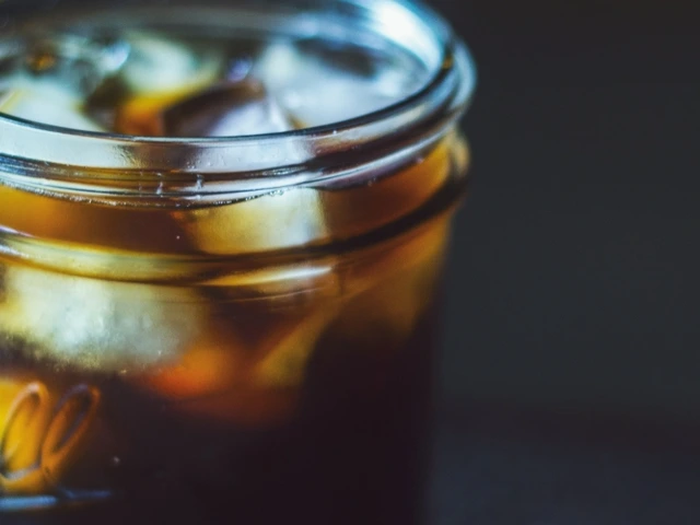 mason jar with ice and soda or tea inside