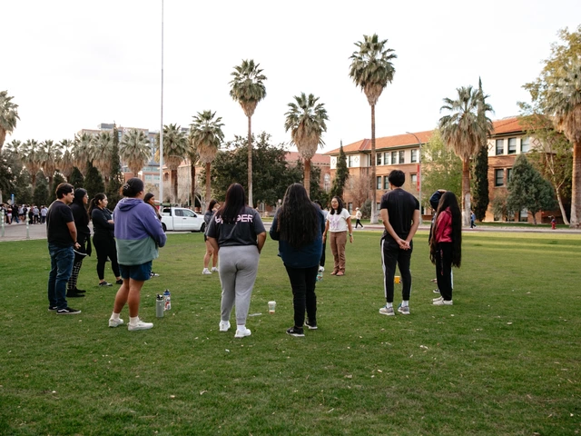 A group of people standing together in a circle on a grass field.