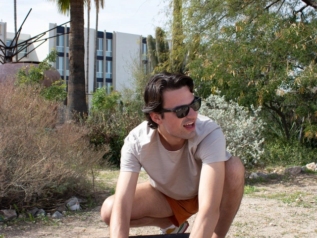 A person squatting down with their hands in a bucket of soil.