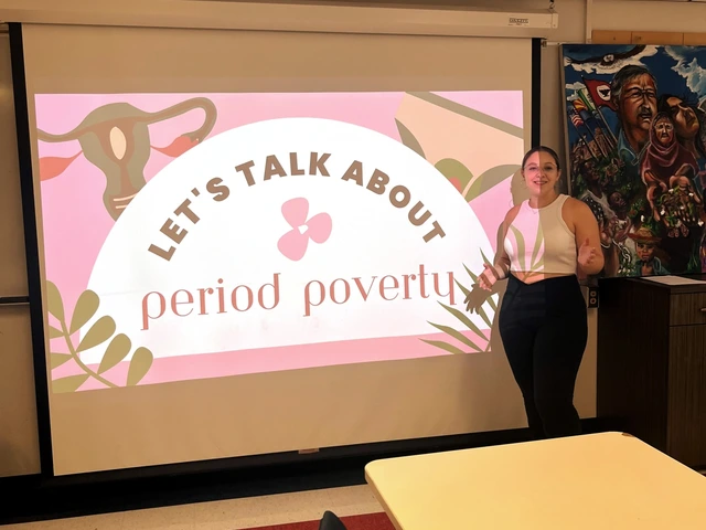 A person standing next to a projector slide starting to present about Period Poverty. 