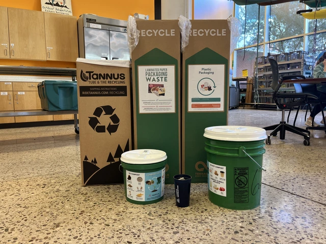three terracycle bins and two composting buckets are arranged on the floor, showing Outdoor Rec's alternate opportunities to minimize their waste as an office