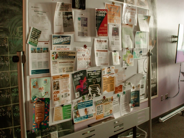 A large whiteboard that is covered in various hanging fliers. 