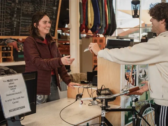 Student paying for services at a cash register.