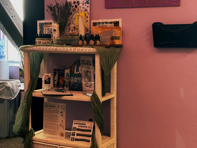 A white botanica station that includes various medicines.