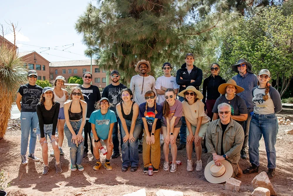 A group of people standing next to each other and smiling for a group photo.