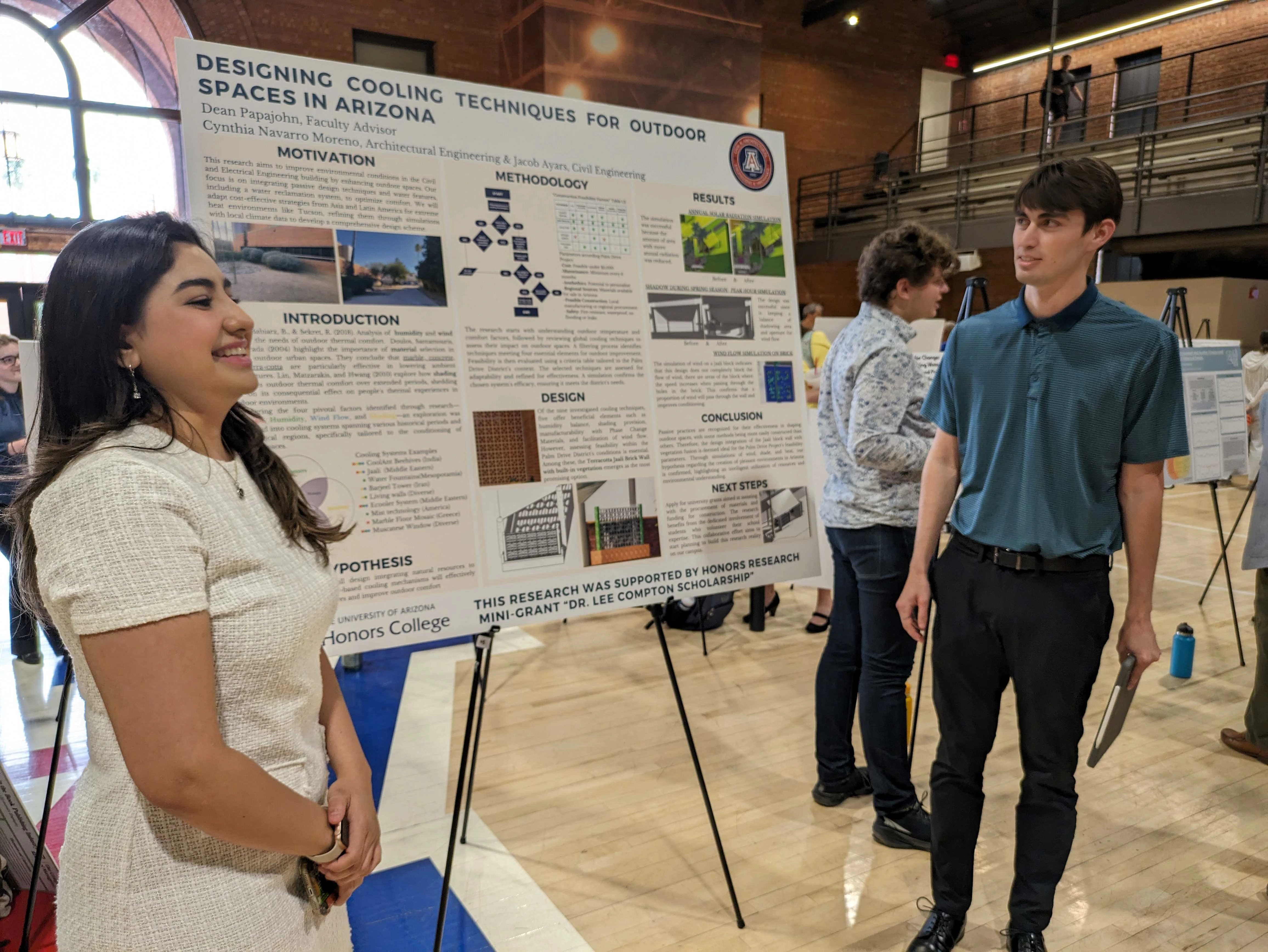 Two students present their posterboard