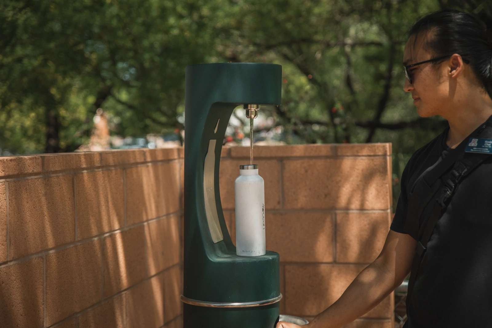 boy filling his bottle at the bottle filling station