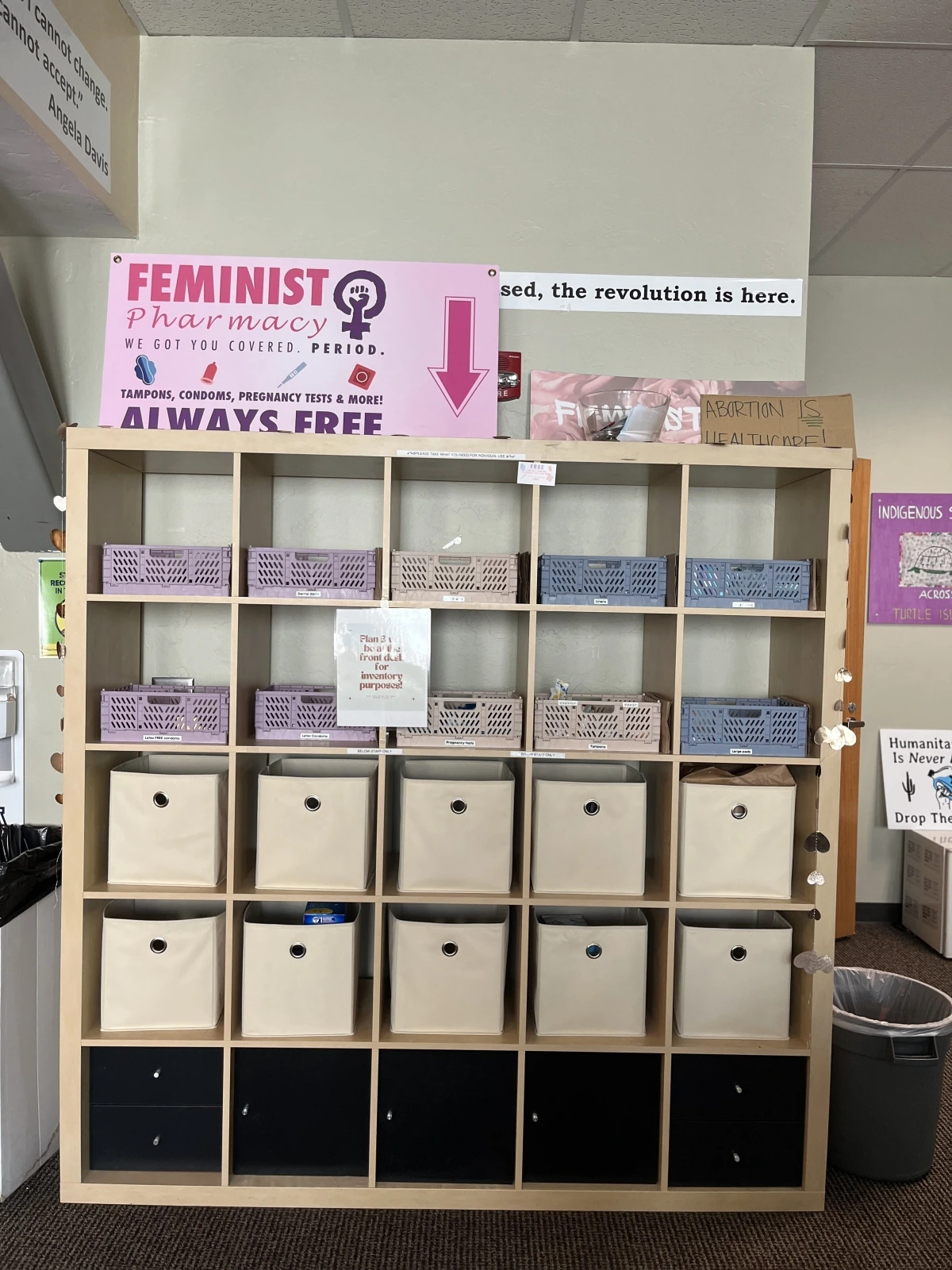 The pharmacy offers many personal hygiene and health products, each in its own cubby. The sign reads "Always free."