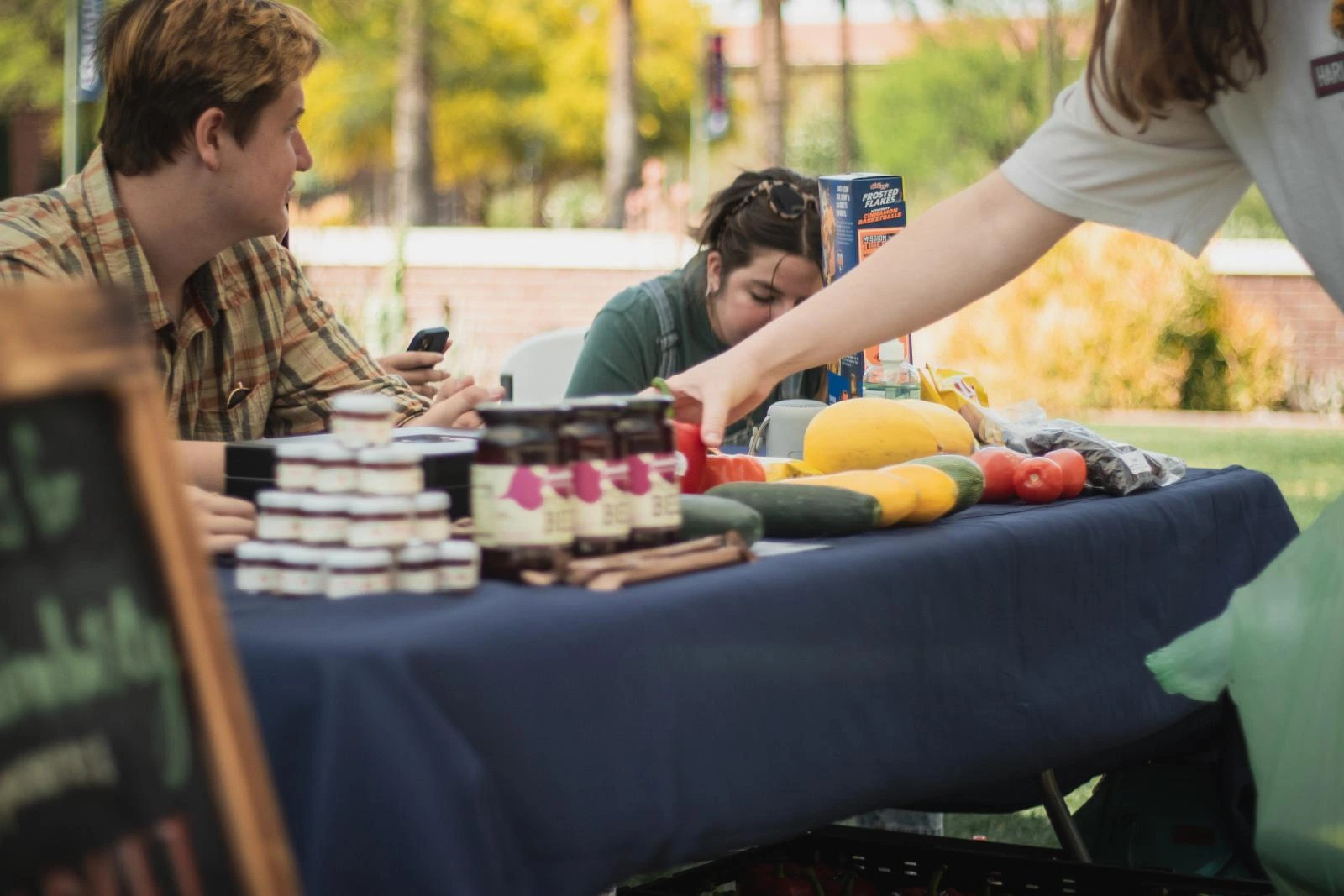 Jam, preserves, and squash are displayed on the table for sale. 
