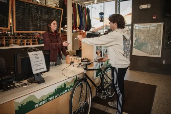 Student checks out a bike at Outdoor Rec counter with CatCard.