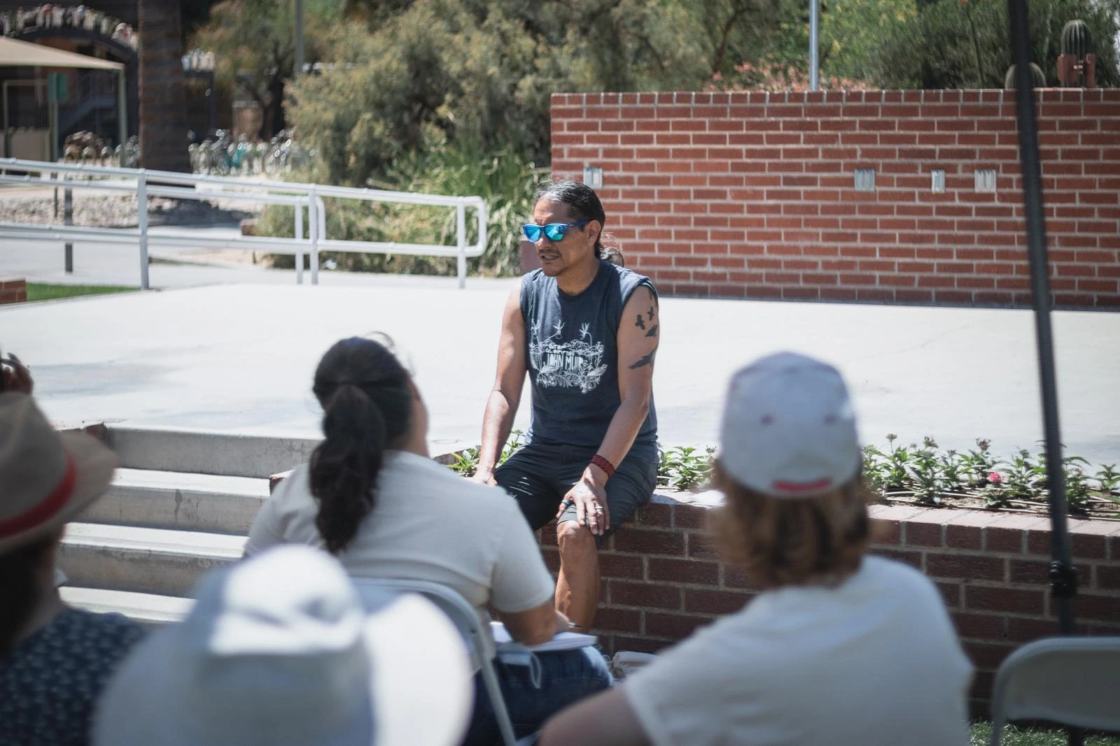 A speaker in front of the attendees at the UA Mall for the Environmental Summit.