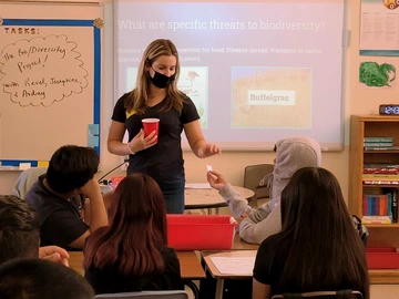 A person teaching a group of students. 