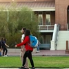 Students walk on paths in front of Old Main.