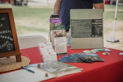 A red table with multiple informative handouts.