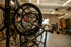 A close up of a bike that is hung up on a bike rack. 