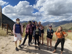 A group of students posing on a mountain.