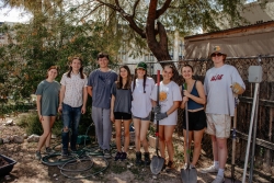 A group of people standing next to each other smiling for a photo.