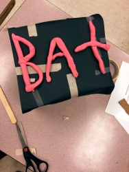 A box that says "Bat" with clay. 