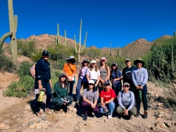 Cohort of students pose in saguharo national park.