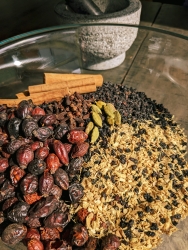 A bowl filled with multiple herbs.