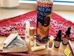 Multiple herbal products being displayed on a wooden holder with a candle in the middle.