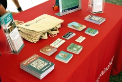 Outreach material that is placed on a table covered in red cloth.