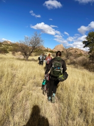 A group of people walking in a desert.