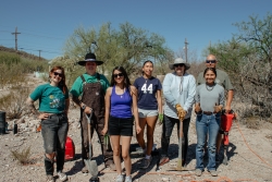 A team of students, staff, and faculty are posing for a group photo. 