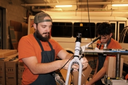 2 people fixing a bike. 