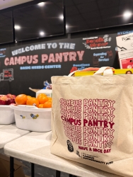 A reusable tote bag filled with food on a table.