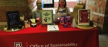 ExtraVAGanza Project team members staff a distribution table at the UArizona Campus Pantry.