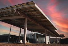 solar panels at sunset with colorful sky in background