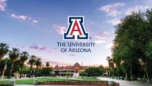 Old Main at sunset with the University of Arizona logo in the sky above the building