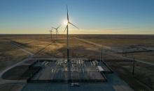 Wind turbine with sun behind the center of the turbine